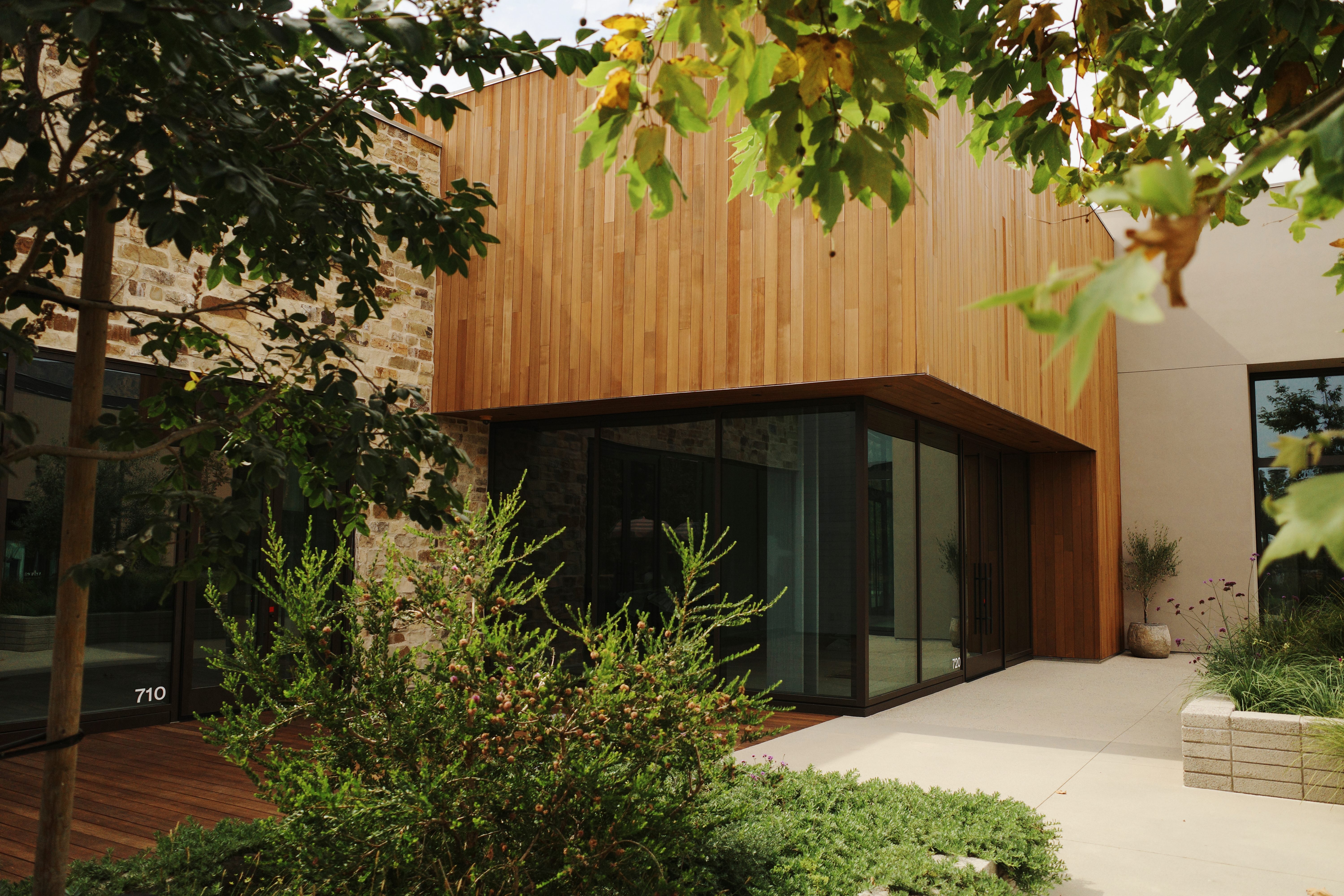 Cross Creek Ranch retail building corner with glass and wood facade.