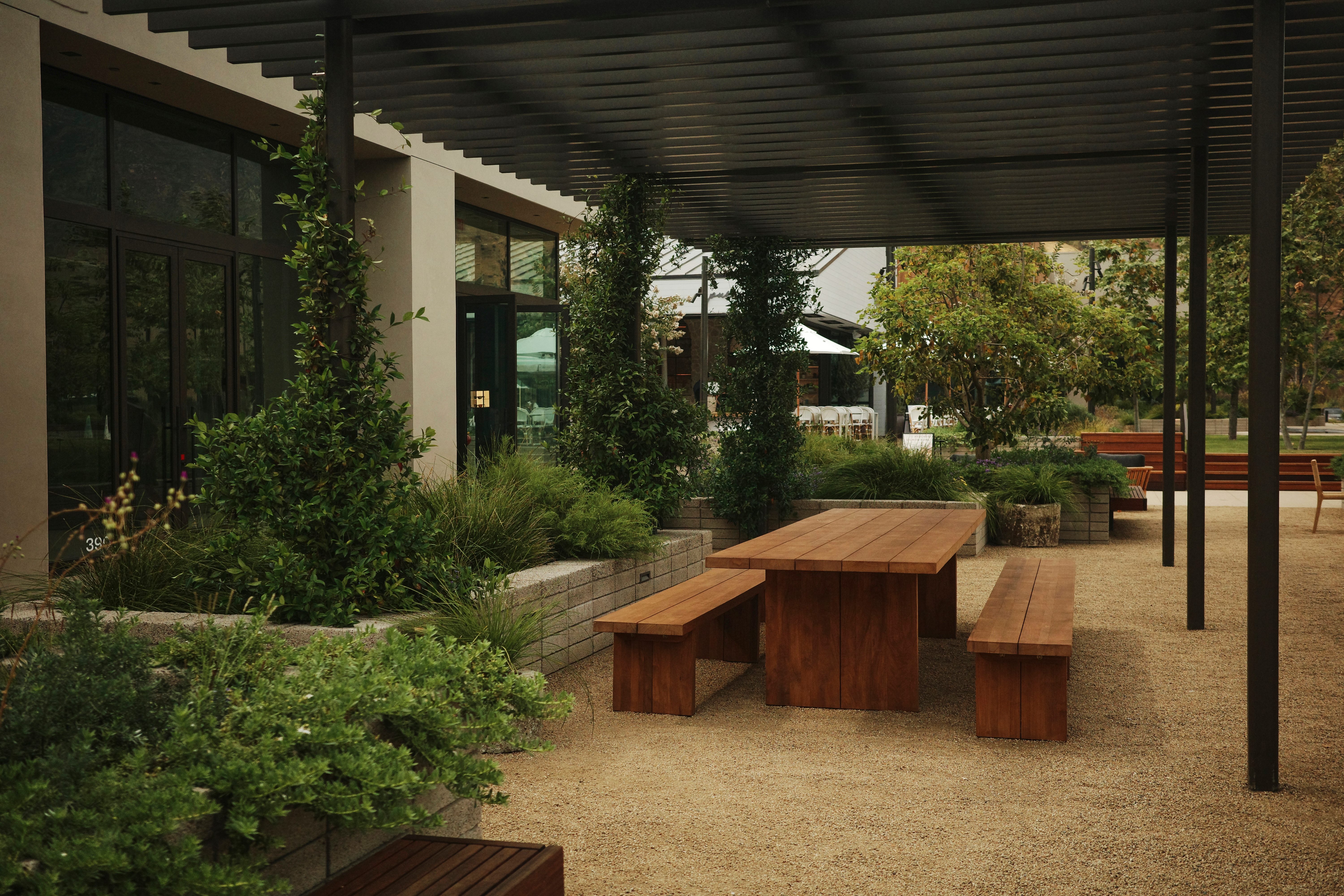 Covered outdoor patio at Cross Creek Ranch with wood picnic table seating.