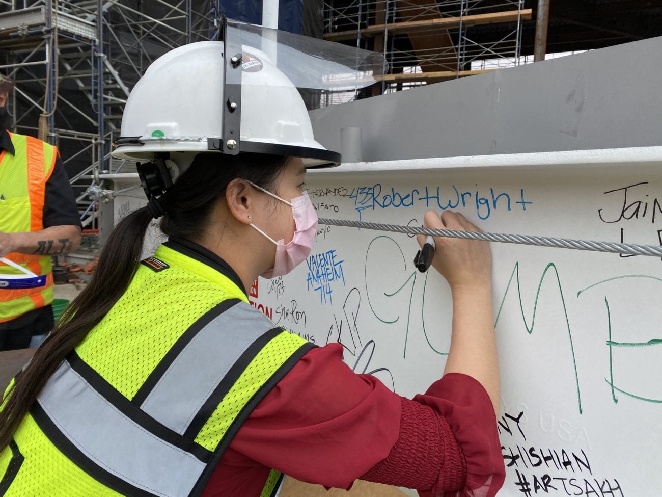 Project Manager, Cory Kuo, signs final steel beam at the (w)rapper