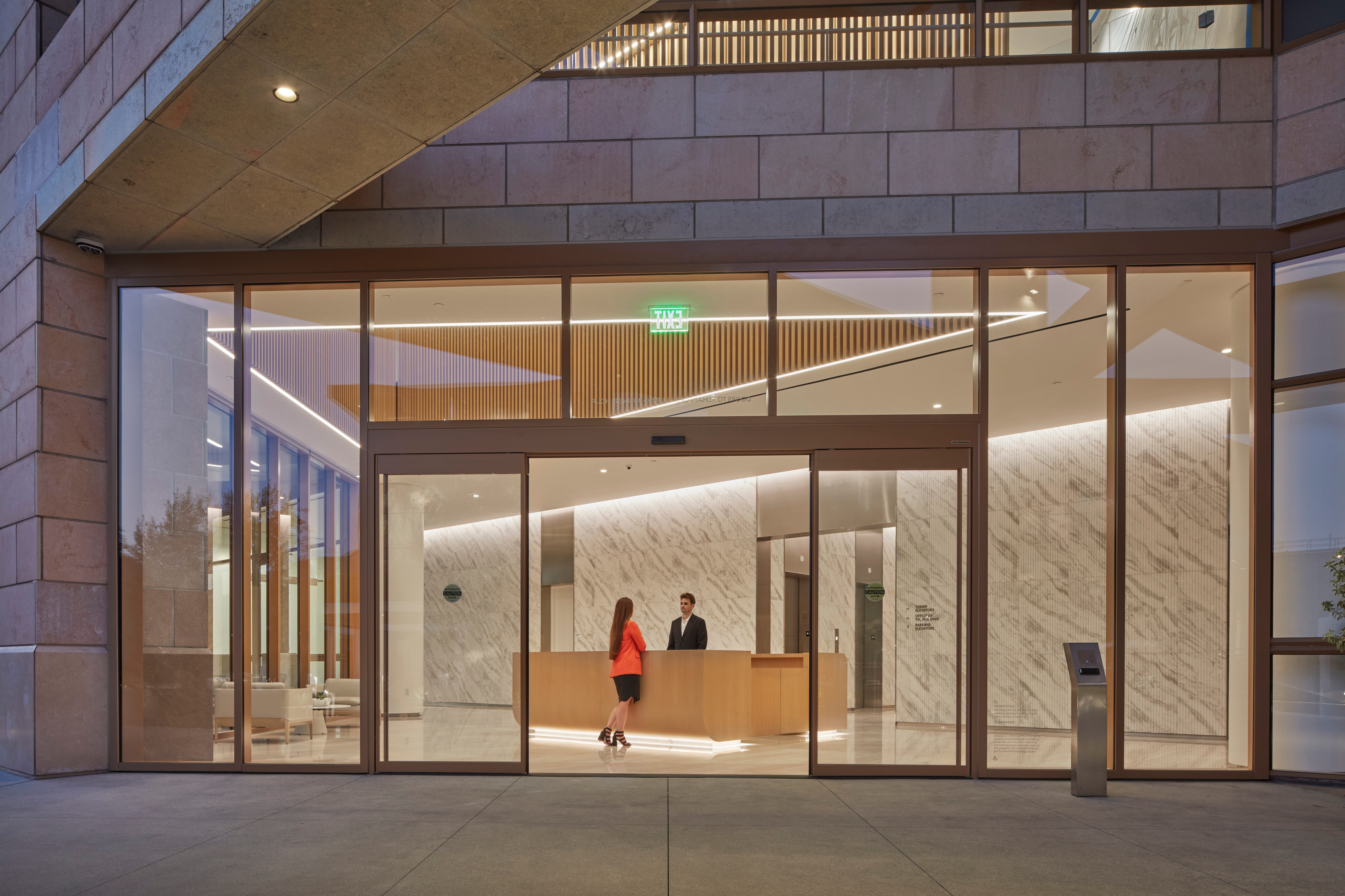 Studio Plaza building entrance and lobby with marble walls and reception desk.