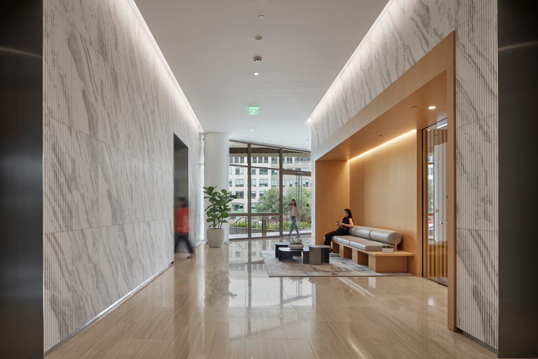 Studio Plaza lobby corridor with marble walls and built-in seating nook.
