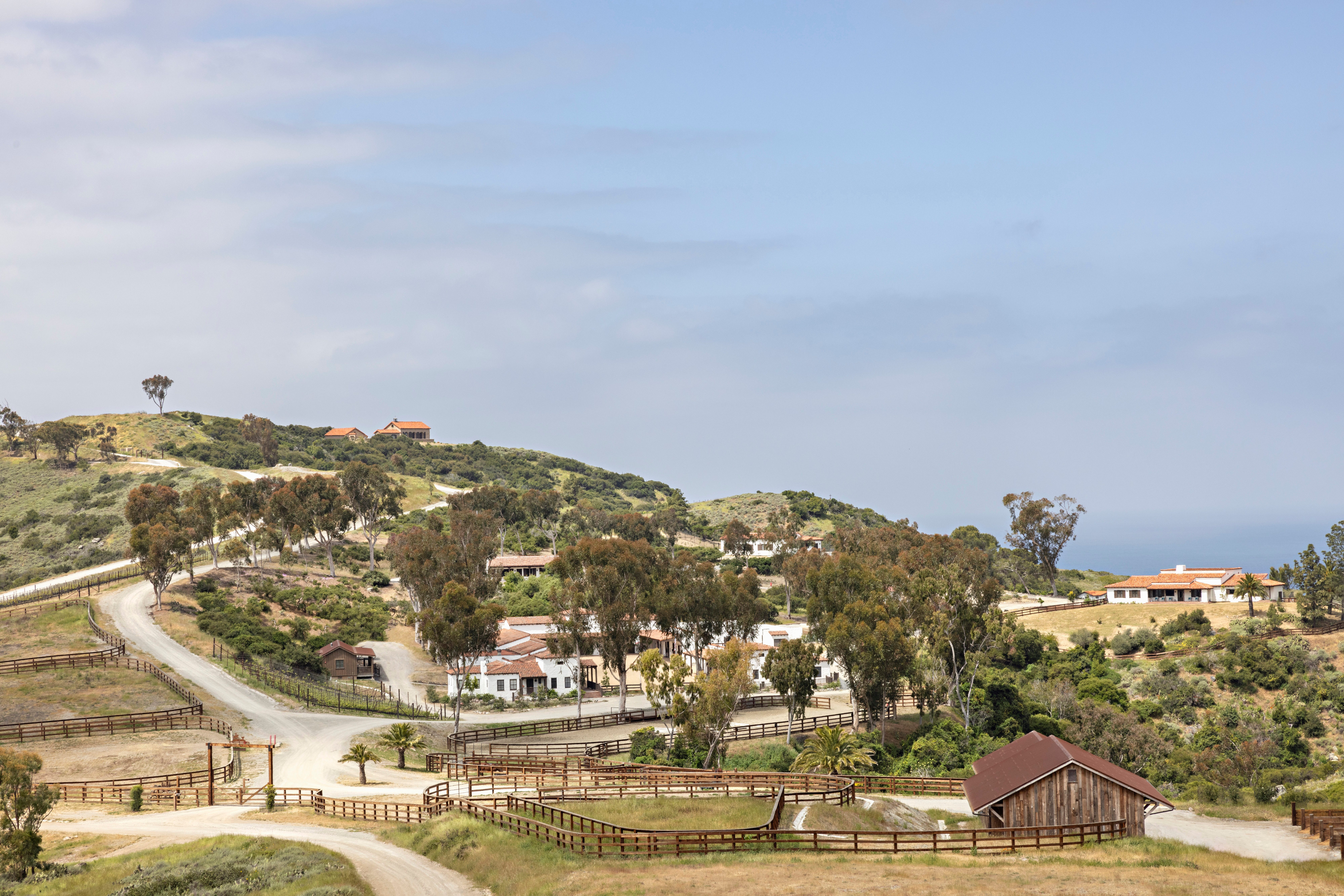 Aerial view of El Rancho Escondido's buildings, corrals, and roads on a Catalina Island hillside.